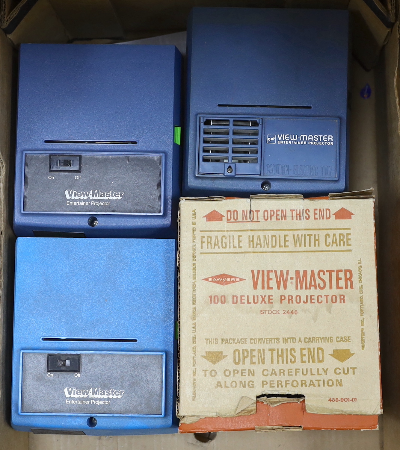 A View-Master metal Standard Projector and three Junior Projectors